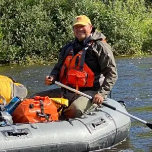 man rafting down the tal river in alaska with tal adventures lodge