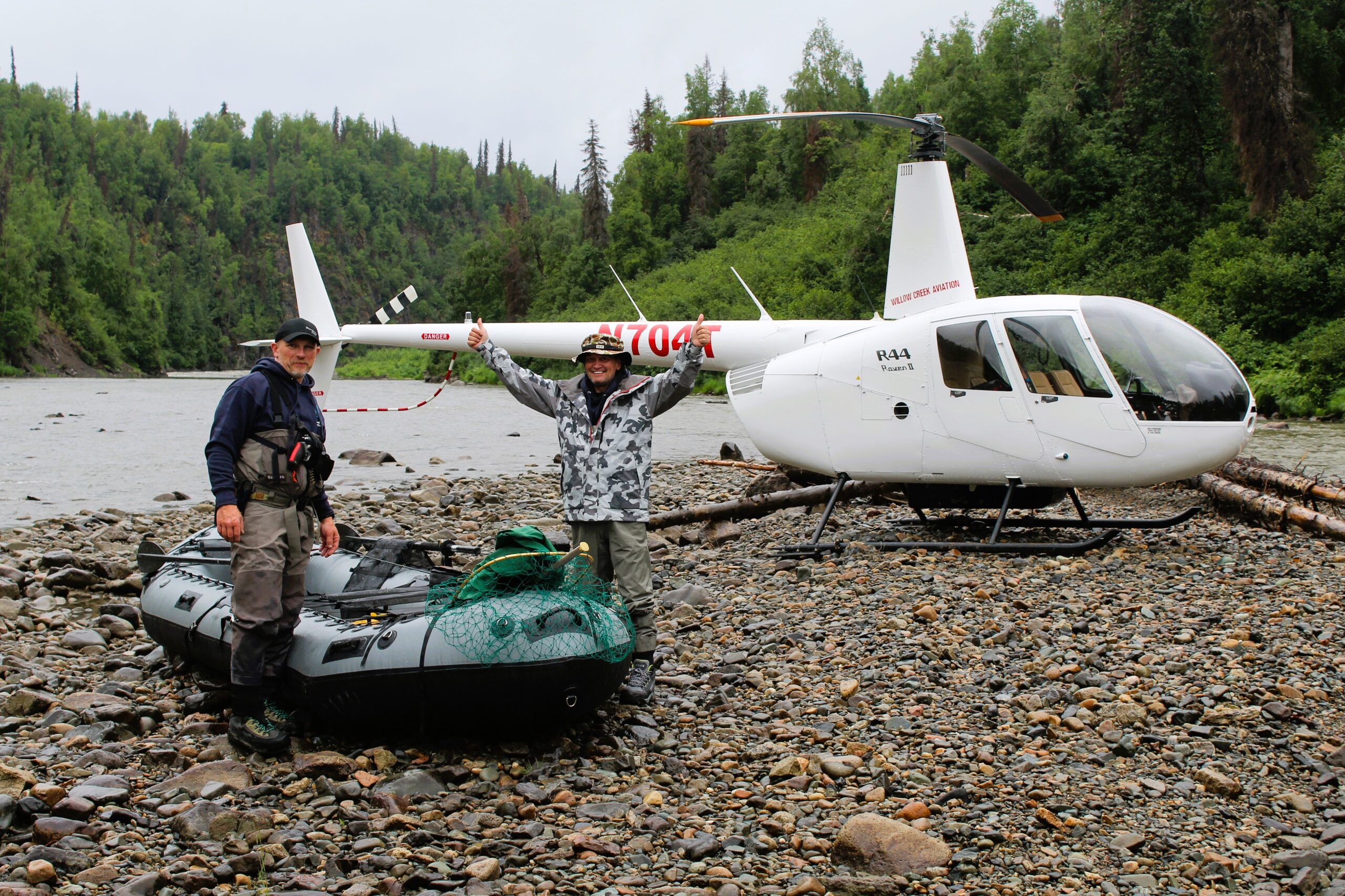 man and raft beside a helicopter on the talachuliltna for a DIY float fishing trip | affordable fishing trips with tal-adventures lodge
