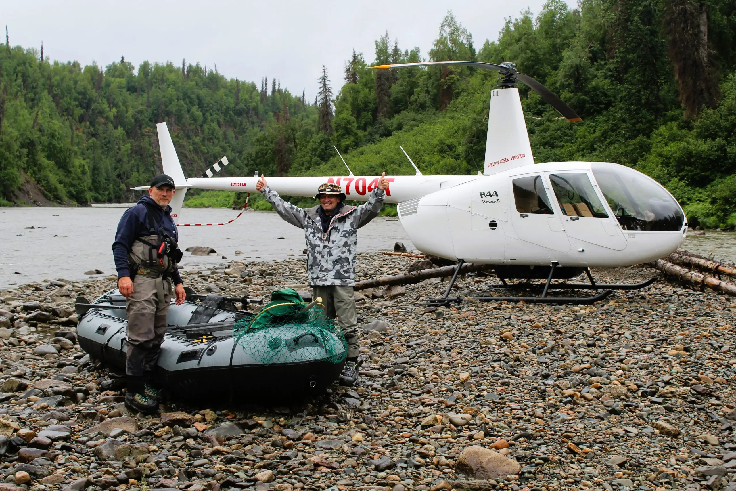 man and raft beside a helicopter on the talachuliltna for a DIY float fishing trip | affordable fishing trips with tal-adventures lodge
